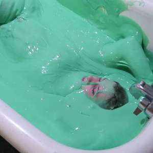 Stella: Stella bathes in a tub filled with 30 gallons of green gunge.