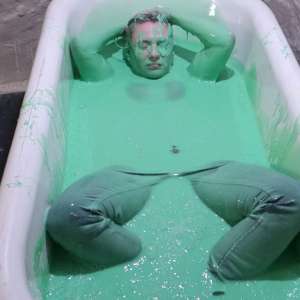 Stella: Stella bathes in a tub filled with 30 gallons of green gunge.